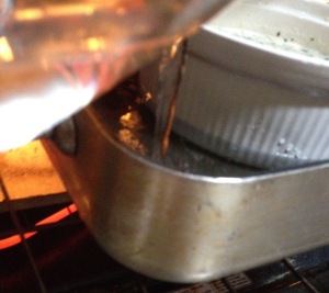 Pour hot water into pan underneath the casserole dish.